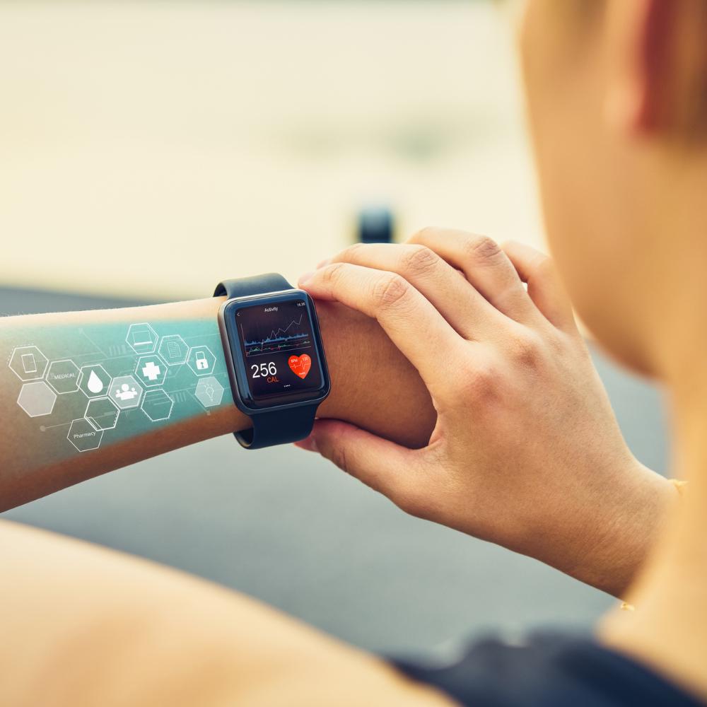 Person using a smartwatch with a blurred background

